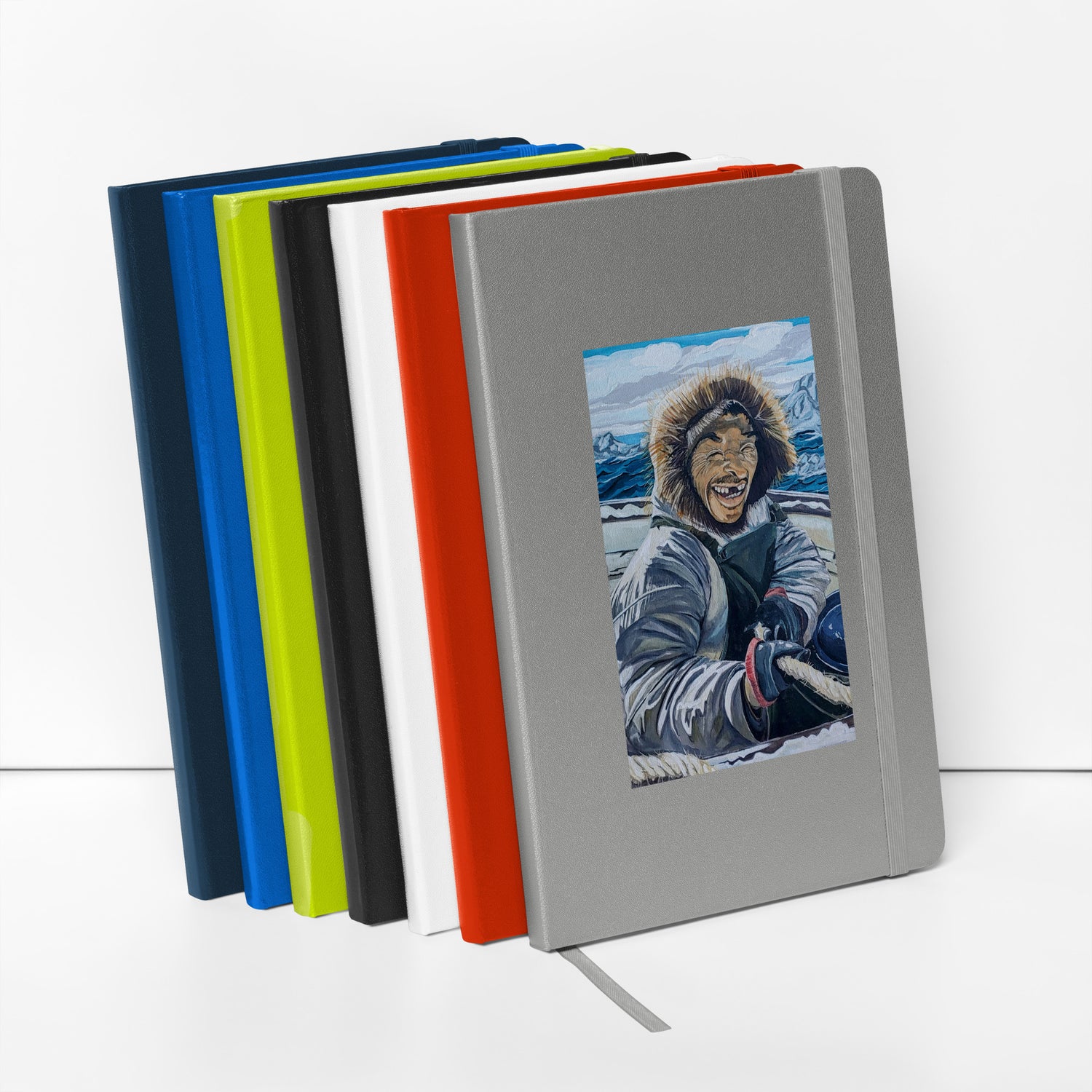A Stack of notebooks with an Inuit in a parka on a boat