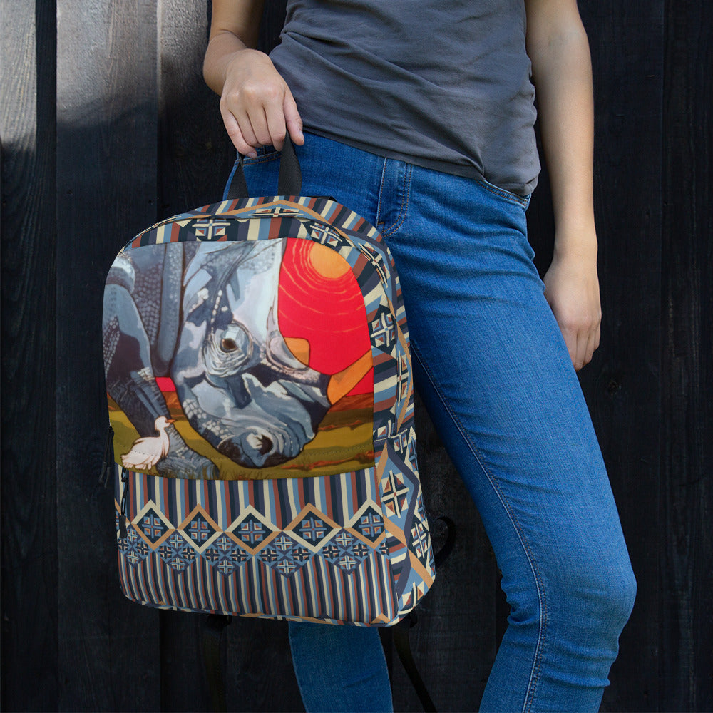 A backpack featuring a rhinoceros in blue on a red background with a white bird.
